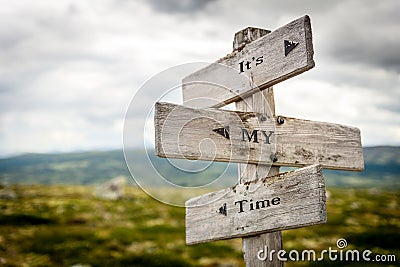 its my time text engraved on old wooden signpost outdoors in nature Cartoon Illustration