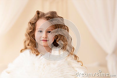 Ittle beautiful caucasian girl with long curly white hair, brown eyes. human, child emotions Stock Photo