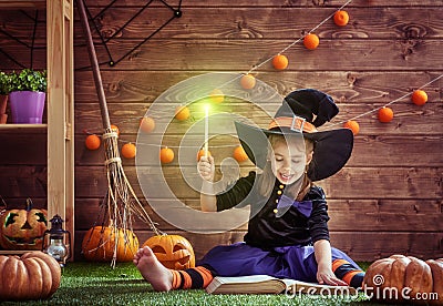 Ittle witch with a magic wand Stock Photo