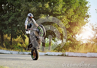 Biker is riding on one cycle along the street. Editorial Stock Photo