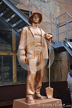 Sculpture of a worker on the territory of the old factory. Editorial Stock Photo