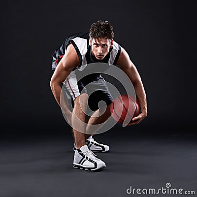 Ive got 99 options, failure aint one of them. Full length portrait of a male basketball player in action against a black Stock Photo