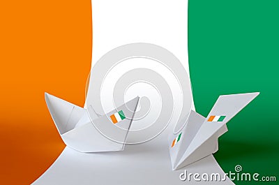 Ivory Coast flag depicted on paper origami airplane and boat. Handmade arts concept Stock Photo