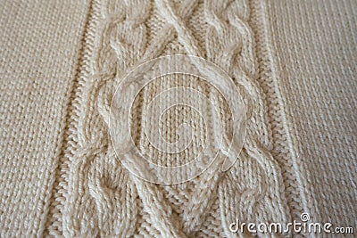 Ivory handmade knitted fabric with plait pattern Stock Photo