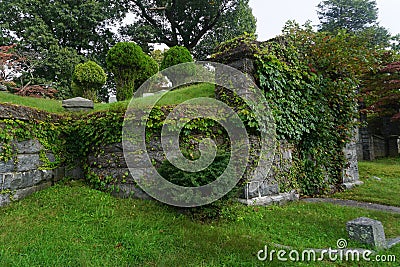 An ivy-covered stone crypt in the Sleepy Hollow Cemetery Stock Photo