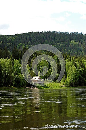 Izba on the Siberian mountain taiga and river Mana Stock Photo