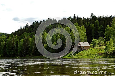 Izba on the Siberian mountain taiga and river Mana Stock Photo