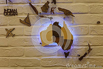 Wooden decorative world map with purple neon backlight on apartment wall. Modern interior design. Editorial Stock Photo