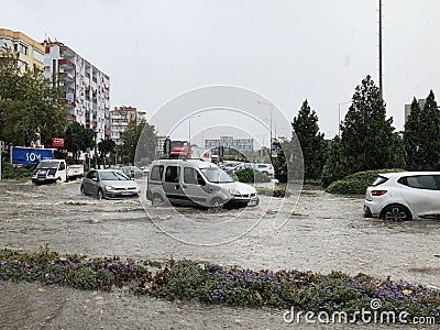 Vehicles have difficulty moving on the flooded road Editorial Stock Photo