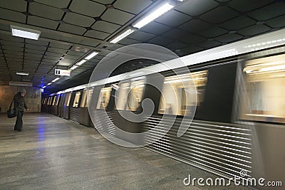 Subway train leaving the station and people waiting for the next one Editorial Stock Photo