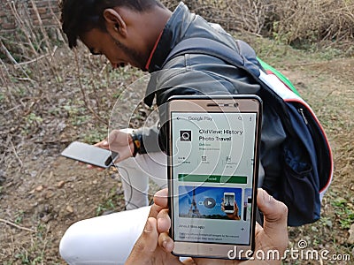 jabalpur, India - December 2019: old view history photo videos app displayed on smart phone screen with holded mobile Editorial Stock Photo