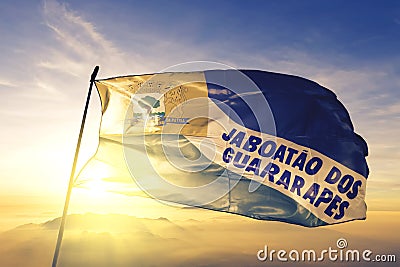 Jaboatao dos Guararapes of Brazil flag waving on the top sunrise mist fog Stock Photo