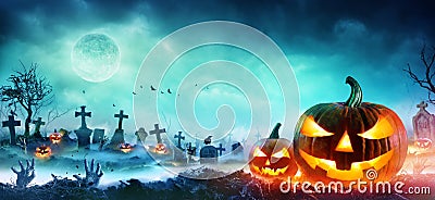 Jack O Lanterns And Zombie Hands Rising Out Of A Graveyard Stock Photo