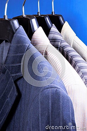 Jackets from suit men`s choice on the hanger in the store. Jacket in the wardrobe of men - decoration, accessory, business clothe Stock Photo