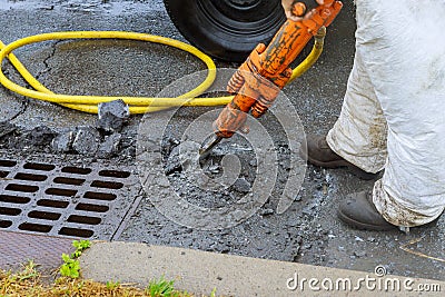 Jackhammer with a pneumatic drill perforating the asphalt of an urban road being renovated on street construction Stock Photo