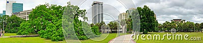 JACKSONVILLE, FL - APRIL 8TH, 2018: City park and buildings on a couldy spring day. - Panoramic view Editorial Stock Photo