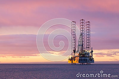 Jackup moveable oil platform at sunset in Gulf of Mexico Stock Photo