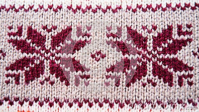 Jacquard knitted pattern. Geometric ornament for Christmas or New Year. Knitted brown snowflakes or flowers on a beige Stock Photo