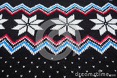 Jacquard knitted pattern. Geometric ornament for Christmas or New Year. Knitted white snowflake, blue zigzag, dots on a Stock Photo