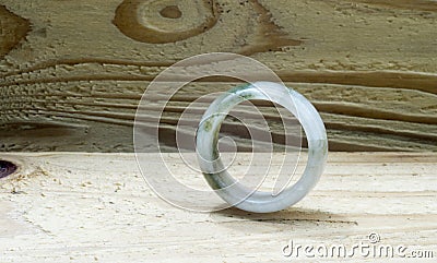 Jade ring on wooden background Stock Photo