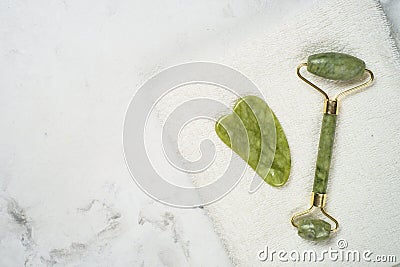 Jade roller and gua sha stone massager for face. Stock Photo