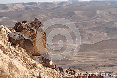 Jagged rock on the edge of the cliff in the desert Stock Photo