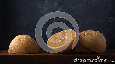 Jaggery, cup shaped unrefined sugar or palm sugar on dark background Stock Photo