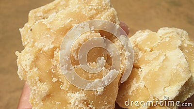 Jaggery is a traditional non-centrifugal cane sugar consumed in the Indian Subcontinent, Southeast Asia, and Africa Stock Photo