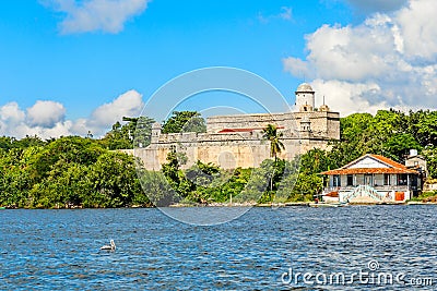 Jagua castle fortified walls with trees and fishing boats in the foreground, Cienfuegos province, Cuba Stock Photo