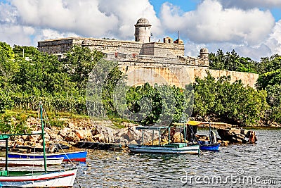 Jagua castle fortified walls with trees and fishing boats in the Editorial Stock Photo