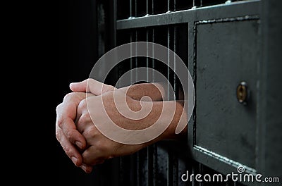 Jail Cell Door And Hands Stock Photo