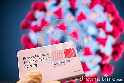 Hydroxychloroquine Sulphate tablets with coronavirus written in background Editorial Stock Photo