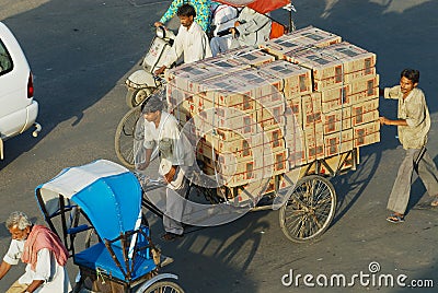 Rickshaw transports boxes with electronics by the street in Jaipur, India. Editorial Stock Photo