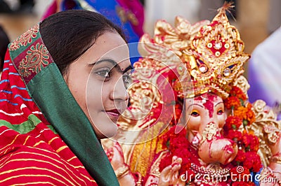 JAISALMER, INDIA - SEPTEMBER 8th: Devotee and the statue of Lord Ganesha during Ganesha Chaturthi festival Editorial Stock Photo