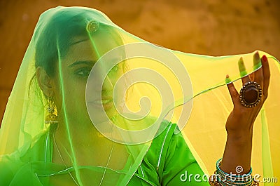 Beautiful Indian woman covers her face with a green cloth saree, woman in veil Editorial Stock Photo