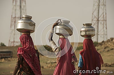 Rajasthani women carrying water jars in the Thar Desert Editorial Stock Photo