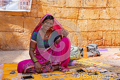 Jaisalmer, Rajasthan, India - October 13, 2019 : Rajasthani woman selling jewelleries in market place Inside Jaisalmer Fort . Editorial Stock Photo