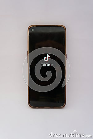 JAKARTA, INDONESIA â€“ August 19, 2021: A man holds a mobile phone that displays a logo design on the Tiktok application Editorial Stock Photo