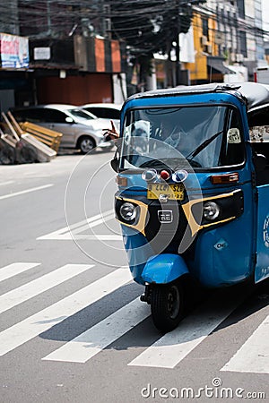 Jakarta, Indonesia - July 23, 2020: The Bajaj`s driver is calling the passenger to ride. Editorial Stock Photo