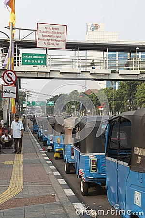 A long line of tuk tuk waiting for new customers in Dr Sutomo Street. Editorial Stock Photo