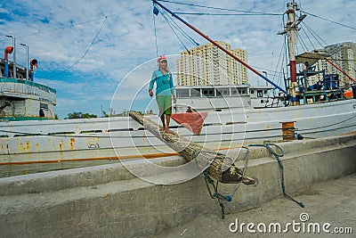 JAKARTA, INDONESIA - 5 MARCH, 2017: Daily activities inside famous old port area of Jakarta, fishing boat lying at Editorial Stock Photo