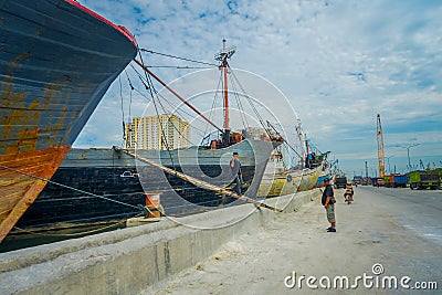 JAKARTA, INDONESIA - 5 MARCH, 2017: Inside famous old port area of Jakarta, fishing boats lying at harbor, fishermen Editorial Stock Photo