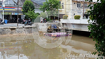 Jakarta, November 1st 2020; The view of ciliwung river side with building and trees background at Jakarta city, Indonesia Editorial Stock Photo