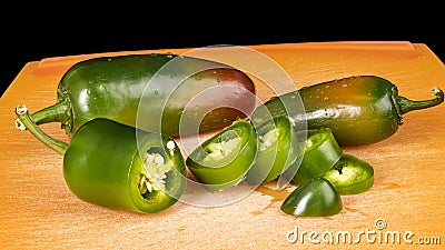 Jalapeno peppers on a cutting board in pieces Stock Photo