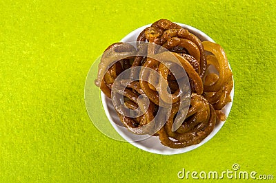 Jalebi Indian sweet dish on green background Stock Photo