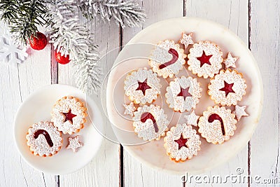 Jam filled Christmas cookies, top view on a marble plate against white wood Stock Photo