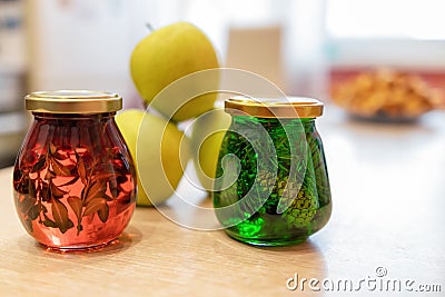 Jam of fir twigs and cones and mountain cranberries in small jars Stock Photo