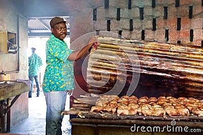 Jamaican cook showing jerk chicken cooking Editorial Stock Photo