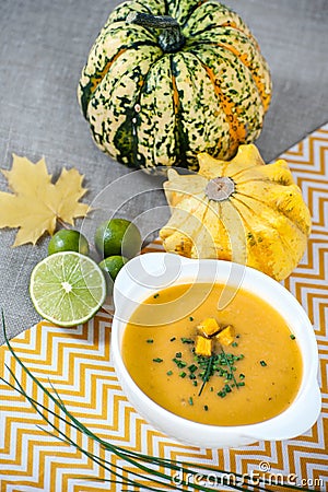 Jamaican pumpkin soup with lime in a white stylish plate. Stock Photo