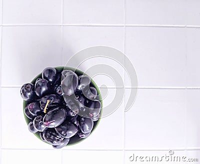 Jamblang or duwet or juwet or java plum or jaam or jamun or black jam or giant duhat on green bowl Stock Photo